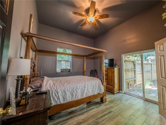 19959 Rheas Community Rd, Lincoln, AR 72744 - bedroom with access to exterior, wood finished floors, multiple windows, a ceiling fan, and vaulted ceiling