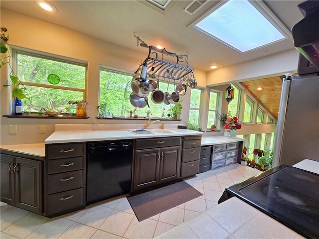 1655 Wilson Springs Rd, Harrison, AR 72601 - kitchen featuring black appliances, light countertops, light tile patterned floors, healthy amount of natural light, and recessed lighting