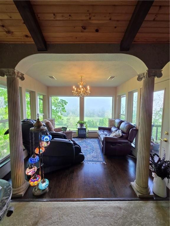 1655 Wilson Springs Rd, Harrison, AR 72601 - living area with ornate columns, arched walkways, wood finished floors, a wooden ceiling with exposed beams, and a chandelier