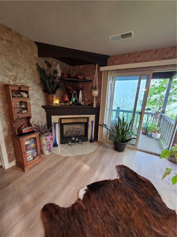 1655 Wilson Springs Rd, Harrison, AR 72601 - living area with wood finished floors, a fireplace with flush hearth, and plenty of natural light