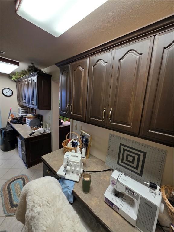1655 Wilson Springs Rd, Harrison, AR 72601 - kitchen featuring dark brown cabinetry, light countertops, and light tile patterned floors
