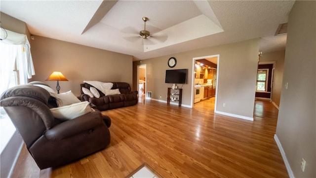 5 Coatbridge Ln, Bella Vista, AR 72715 - living room with wood finished floors, ceiling fan, and a tray ceiling