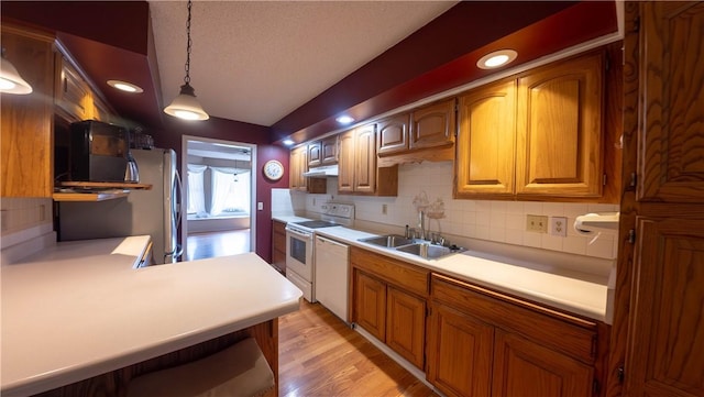 5 Coatbridge Ln, Bella Vista, AR 72715 - kitchen with under cabinet range hood, white appliances, tasteful backsplash, light countertops, and light wood-style floors