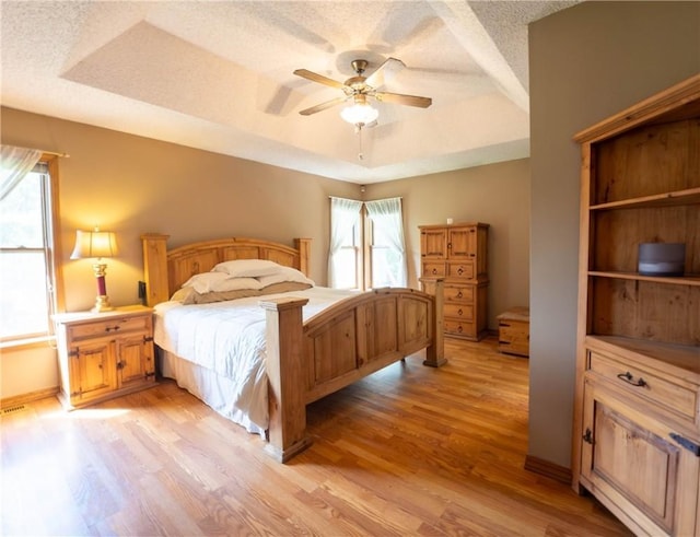 5 Coatbridge Ln, Bella Vista, AR 72715 - bedroom with light wood-style floors, a raised ceiling, multiple windows, and a textured ceiling