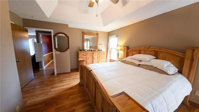 5 Coatbridge Ln, Bella Vista, AR 72715 - bedroom featuring wood finished floors, a ceiling fan, and a tray ceiling