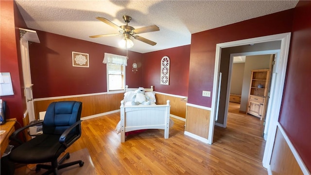 5 Coatbridge Ln, Bella Vista, AR 72715 - office space with wainscoting, a ceiling fan, wood finished floors, a textured ceiling, and wood walls