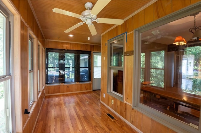 5 Coatbridge Ln, Bella Vista, AR 72715 - unfurnished sunroom featuring plenty of natural light, wooden walls, wood finished floors, and ornamental molding