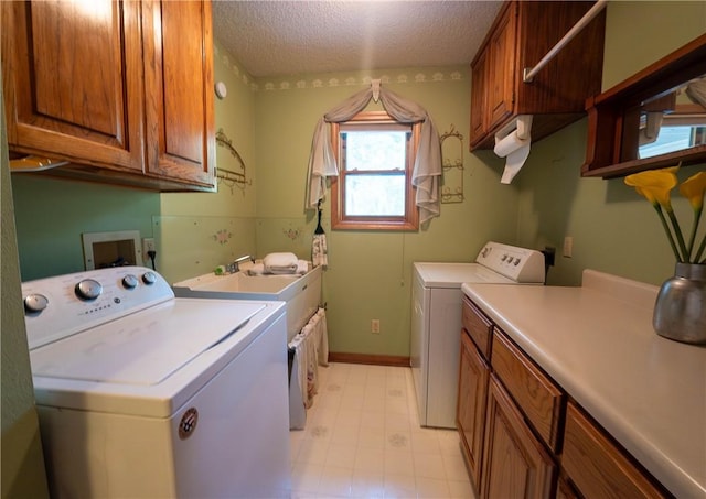 5 Coatbridge Ln, Bella Vista, AR 72715 - laundry area featuring washer and dryer, cabinet space, and a textured ceiling