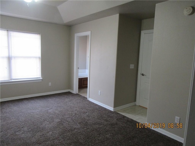 1110 Courage, Siloam Springs, AR 72761 - unfurnished bedroom with light colored carpet, vaulted ceiling, ensuite bathroom, and light tile patterned floors