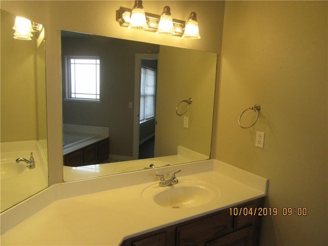 1110 Courage, Siloam Springs, AR 72761 - bathroom featuring vanity, a garden tub, and a chandelier
