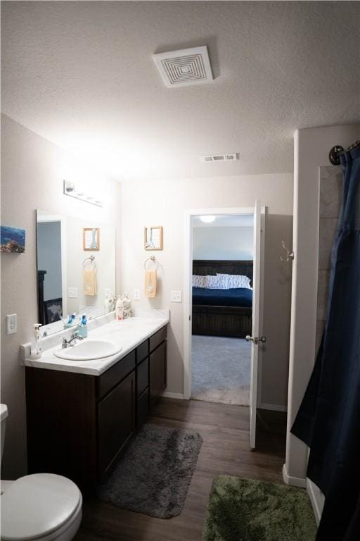 233 Evans St, Huntsville, AR 72740 - ensuite bathroom with wood finished floors, vanity, and a shower with shower curtain