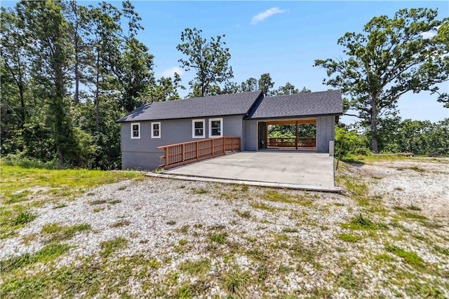 17707 12th Hwy, Rogers, AR 72756 - view of front facade featuring an attached carport, driveway, a wooden deck, and roof with shingles