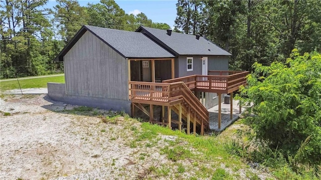 17707 12th Hwy, Rogers, AR 72756 - back of property featuring a wooden deck, a shingled roof, and stairway