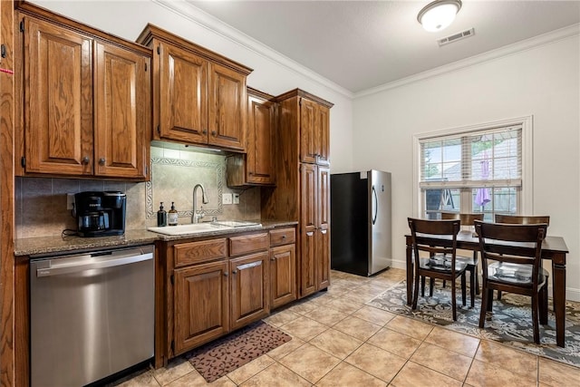 793 Buckhead Ave, Springdale, AR 72764 - kitchen with stainless steel appliances, crown molding, backsplash, light tile patterned floors, and brown cabinetry