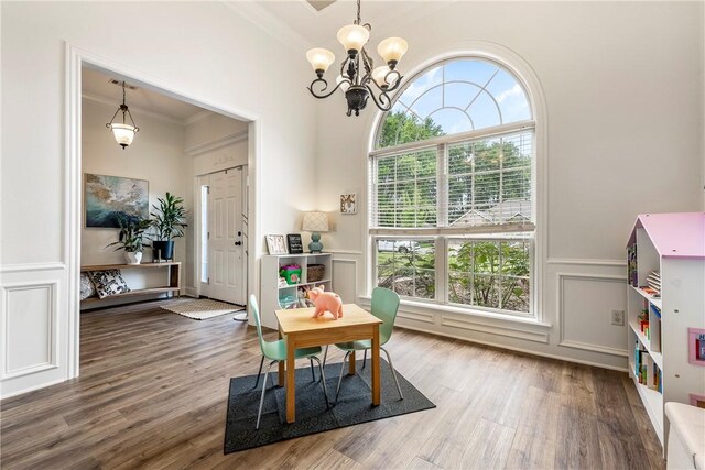 793 Buckhead Ave, Springdale, AR 72764 - dining room with a chandelier, plenty of natural light, ornamental molding, wood finished floors, and a wainscoted wall