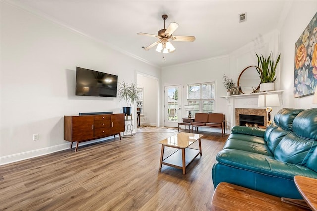793 Buckhead Ave, Springdale, AR 72764 - living area with a ceiling fan, a warm lit fireplace, wood finished floors, and ornamental molding