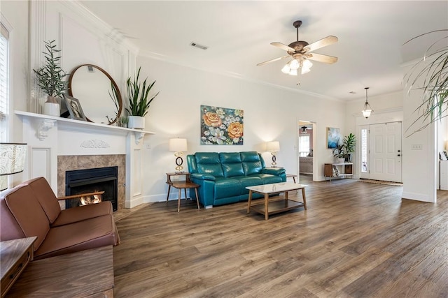 793 Buckhead Ave, Springdale, AR 72764 - living room with wood finished floors, ceiling fan, a tiled fireplace, and crown molding
