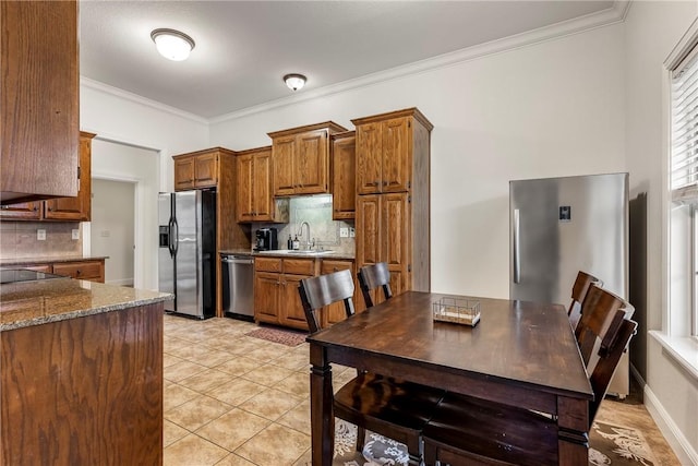 793 Buckhead Ave, Springdale, AR 72764 - kitchen featuring appliances with stainless steel finishes, tasteful backsplash, brown cabinets, crown molding, and light tile patterned flooring