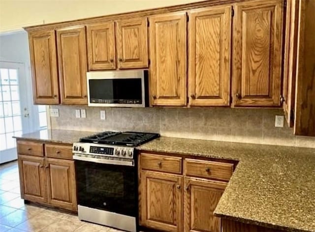 793 Buckhead Ave, Springdale, AR 72764 - kitchen featuring appliances with stainless steel finishes, decorative backsplash, and brown cabinetry
