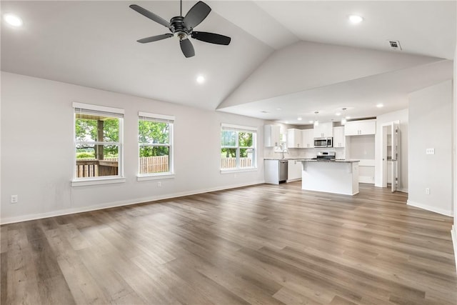 106 N Lion Dr, Gravette, AR 72736 - unfurnished living room with vaulted ceiling, a ceiling fan, recessed lighting, and wood finished floors