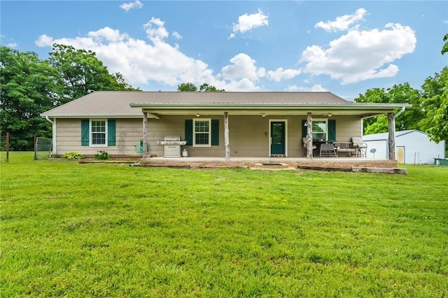 22006 Bozarth Cemetery Rd, Gentry, AR 72734 - back of house featuring a yard, a metal roof, and a porch
