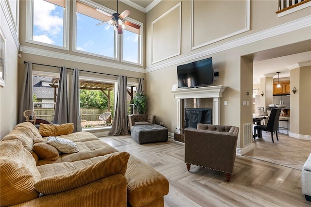 2301 SW Farringdon Ave, Bentonville, AR 72713 - living area featuring a ceiling fan, a high ceiling, and a fireplace