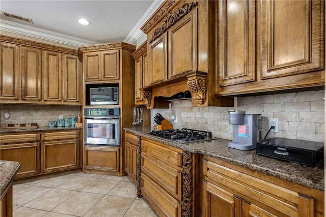 2301 SW Farringdon Ave, Bentonville, AR 72713 - kitchen with stainless steel appliances, brown cabinetry, crown molding, light tile patterned floors, and backsplash