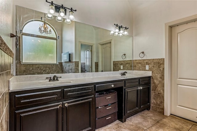 2301 SW Farringdon Ave, Bentonville, AR 72713 - bathroom with tile walls, a chandelier, tile patterned flooring, double vanity, and wainscoting