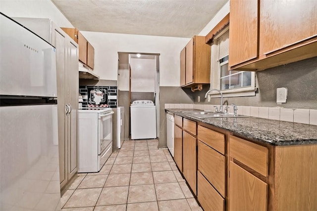 20724 E 578th Rd, Colcord, OK 74338 - kitchen featuring white appliances, under cabinet range hood, light tile patterned flooring, a textured ceiling, and dark stone counters