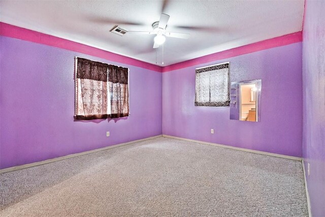 20724 E 578th Rd, Colcord, OK 74338 - spare room with ceiling fan, carpet, and a textured ceiling
