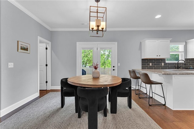 3205 Summer View Ave, Springdale, AR 72764 - dining room with dark wood-type flooring, crown molding, and a chandelier