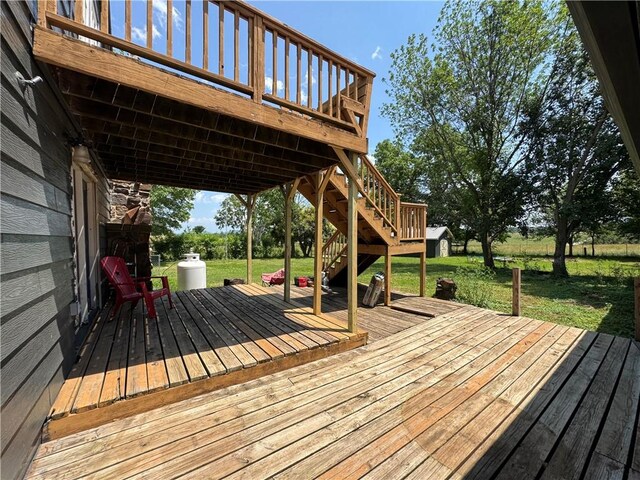 7792 Bubbling Springs Rd, Harrison, AR 72601 - wooden terrace with a yard, stairs, and a storage shed