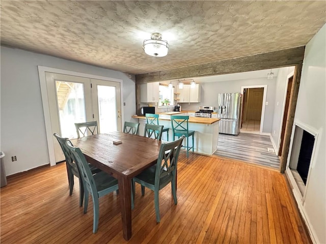 7792 Bubbling Springs Rd, Harrison, AR 72601 - dining room featuring light wood-style floors and french doors