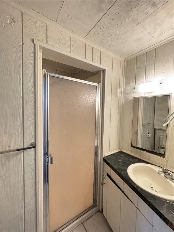 7792 Bubbling Springs Rd, Harrison, AR 72601 - bathroom with a stall shower, vanity, and tile patterned flooring