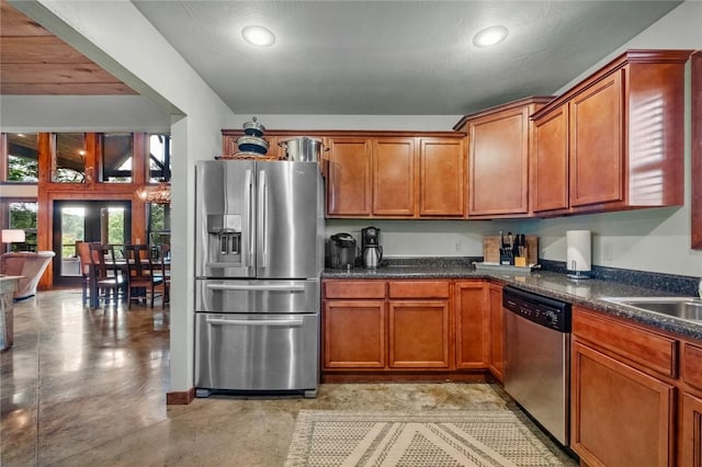 8715 Rambo N Rd, Rogers, AR 72756 - kitchen featuring appliances with stainless steel finishes, concrete floors, dark countertops, brown cabinets, and recessed lighting
