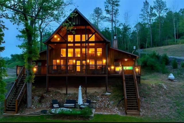 8715 Rambo N Rd, Rogers, AR 72756 - rear view of house featuring stairs, a deck, and a chimney