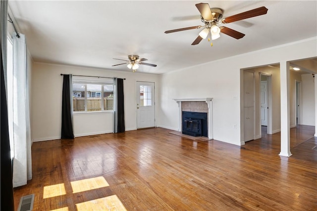 520 S 13th St, Rogers, AR 72758 - unfurnished living room featuring a ceiling fan, a fireplace, wood finished floors, and crown molding
