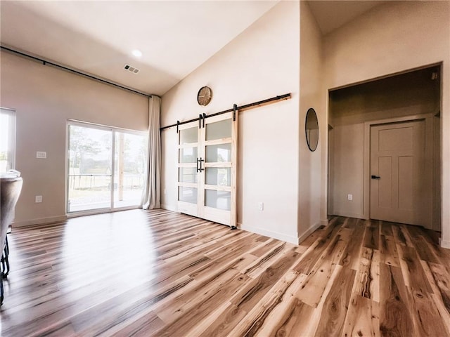 5807 Farm Rd Unit 2212, Washburn, MO 65772 - spare room with high vaulted ceiling, light wood-style flooring, and a barn door