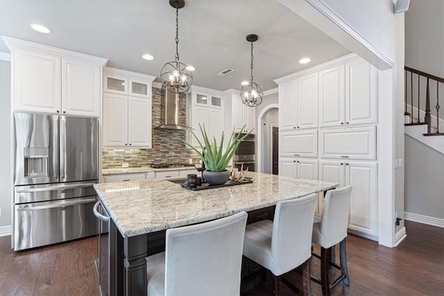 5208 43rd St, Rogers, AR 72758 - kitchen with appliances with stainless steel finishes, wall chimney range hood, a center island, tasteful backsplash, and dark wood-style floors
