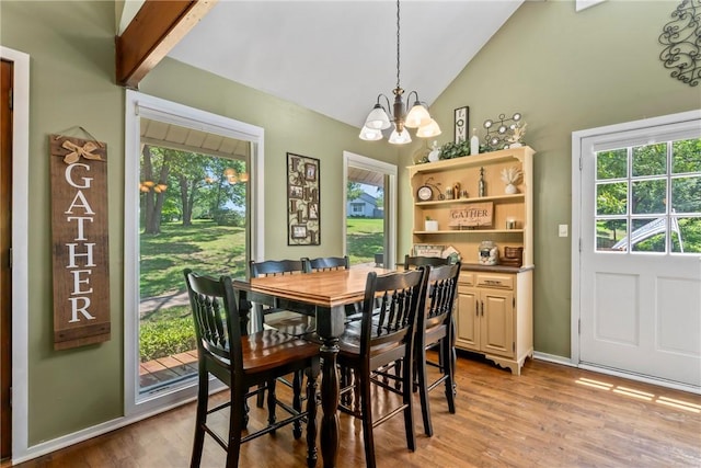 14269 Lake Forrest Heights Rd, Siloam Springs, AR 72761 - dining space with a chandelier, vaulted ceiling, plenty of natural light, and light wood-style flooring