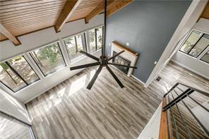 26 Norwood Dr, Bella Vista, AR 72714 - unfurnished living room with beamed ceiling and wood finished floors