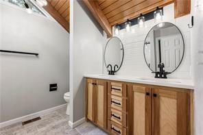 26 Norwood Dr, Bella Vista, AR 72714 - bathroom with wood ceiling and double vanity