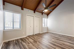 26 Norwood Dr, Bella Vista, AR 72714 - unfurnished bedroom with wooden ceiling, two closets, and wood finished floors