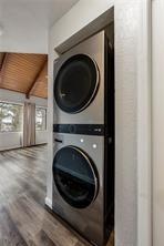 26 Norwood Dr, Bella Vista, AR 72714 - laundry area with stacked washer / drying machine and wood finished floors