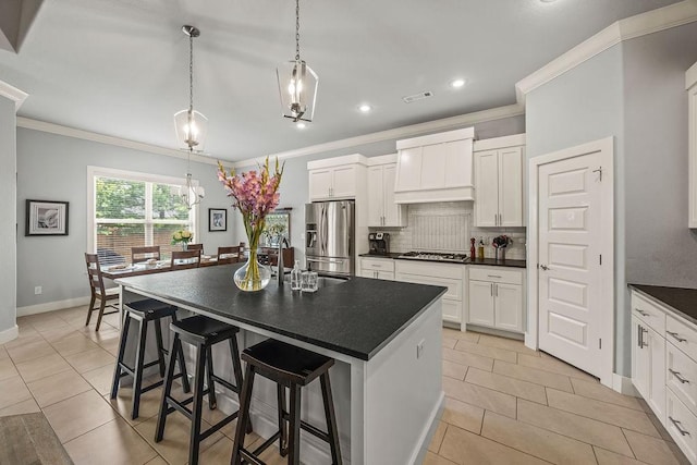 4609 W Waters Edge Dr, Rogers, AR 72758 - kitchen with appliances with stainless steel finishes, dark countertops, custom exhaust hood, crown molding, and light tile patterned floors