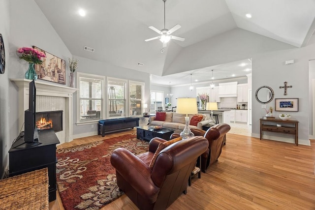 4609 W Waters Edge Dr, Rogers, AR 72758 - living area with vaulted ceiling, light wood finished floors, ceiling fan, recessed lighting, and a tile fireplace