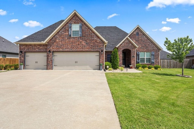 4609 W Waters Edge Dr, Rogers, AR 72758 - traditional-style home featuring brick siding, concrete driveway, and roof with shingles