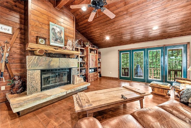 8092 Fain Dr, Rogers, AR 72756 - living area featuring wood ceiling, vaulted ceiling, wood-type flooring, a stone fireplace, and wooden walls