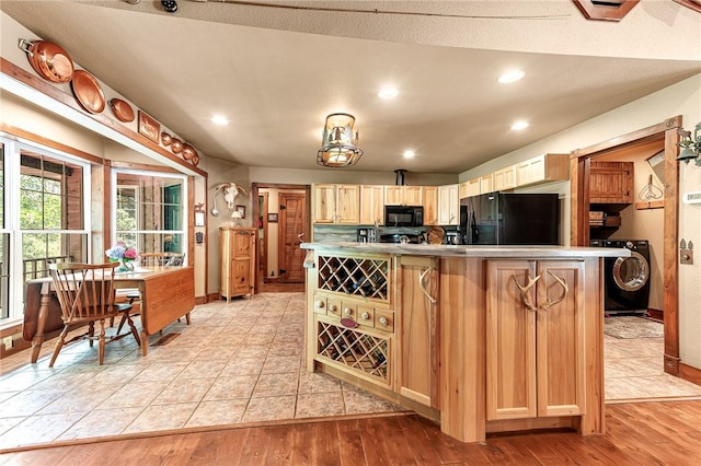 8092 Fain Dr, Rogers, AR 72756 - kitchen with black appliances, washer / clothes dryer, light wood-style floors, a center island, and recessed lighting