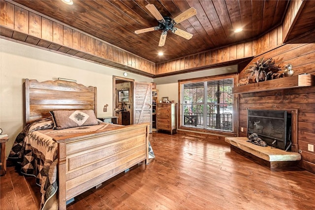 8092 Fain Dr, Rogers, AR 72756 - bedroom featuring wooden ceiling, hardwood / wood-style floors, a fireplace with raised hearth, and ceiling fan